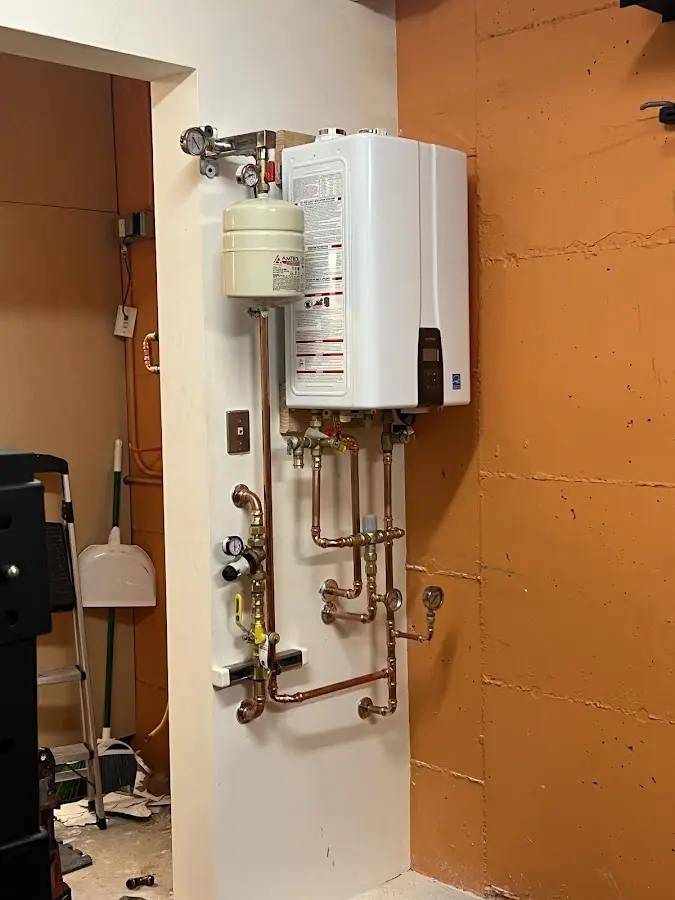 Plumbing technician inspecting water heater connections in Memphis